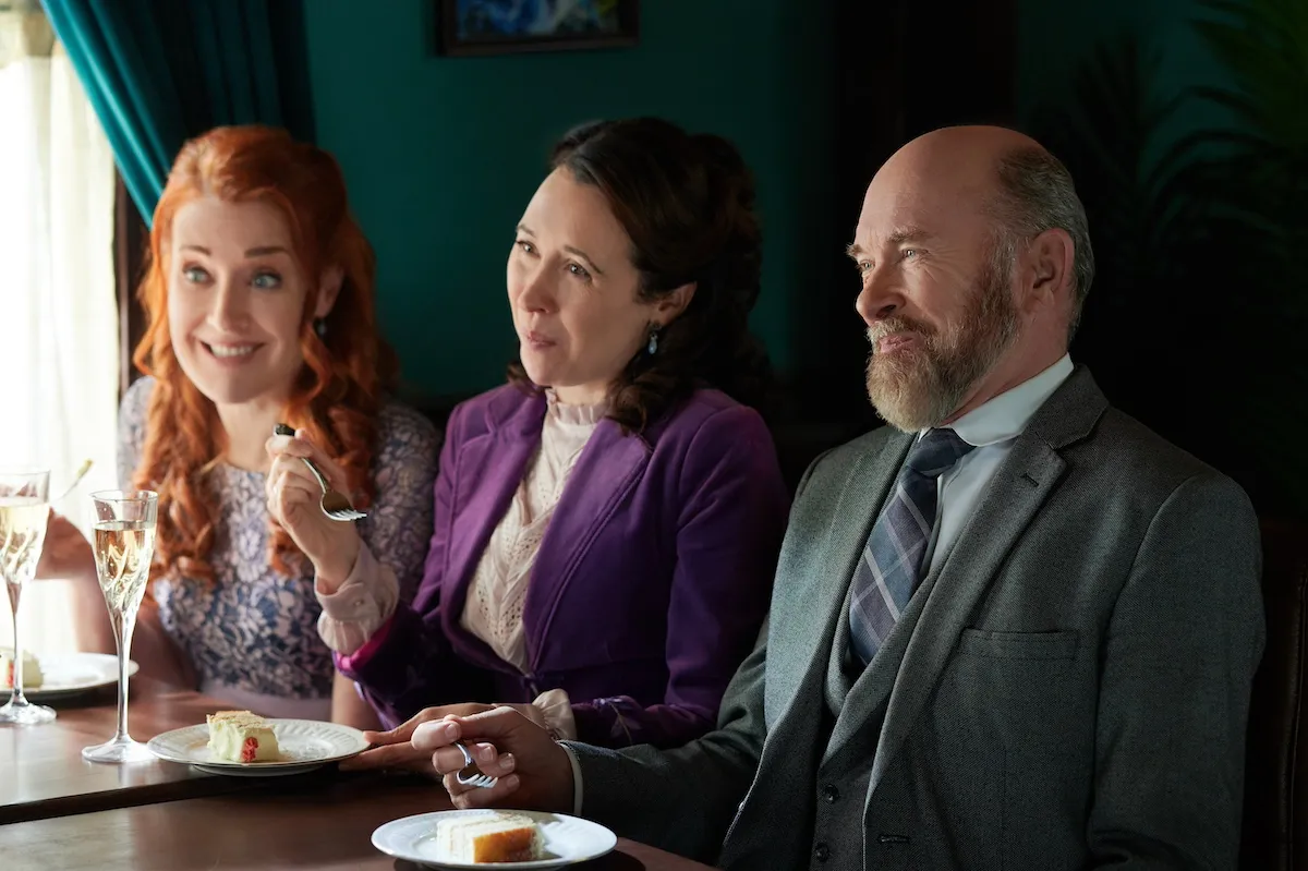 Molly, Florence, and Ned sitting in a row in the 'When Calls the Heart' Season 11 finale.