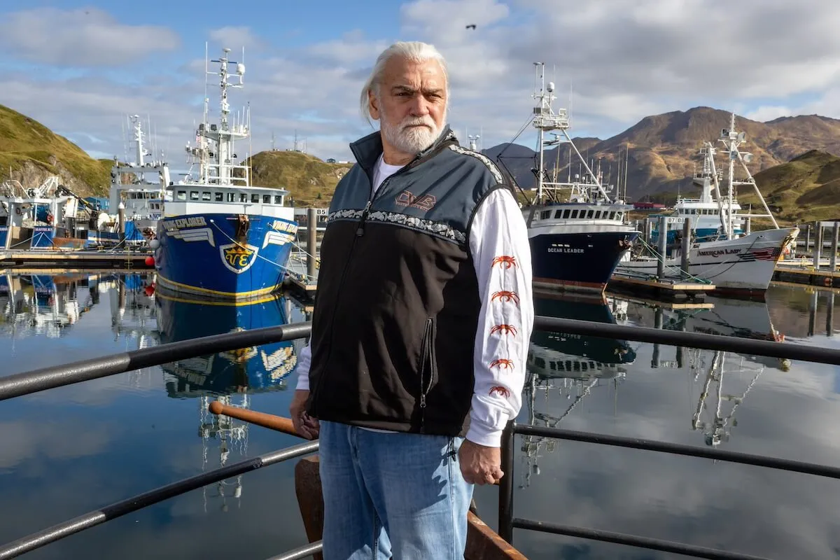 Captain Wild Bill Wichrowski standing in front of fishing boats