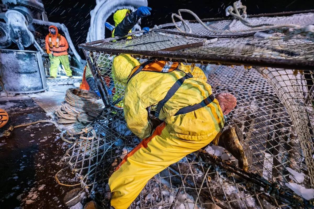 A crew member wrangling a crab pot on 'Deadliest Catch' Season 20