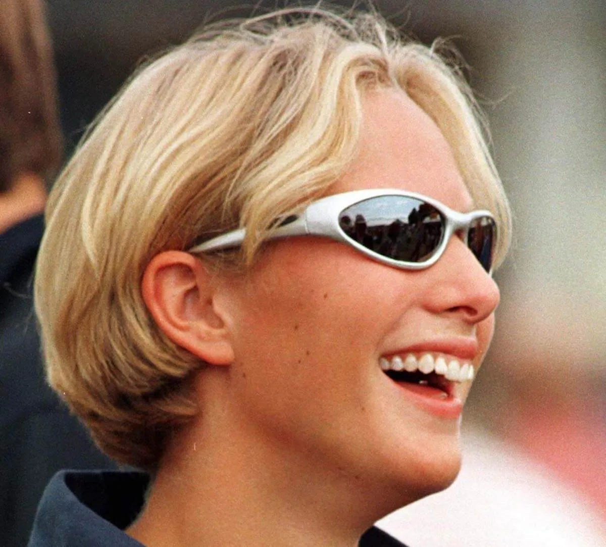 Zara Tindall smiles, showing her tongue piercing.