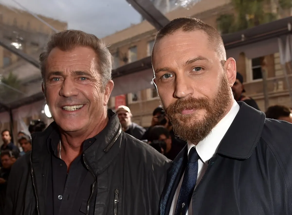 Tom Hardy posing alongside Mel Gibson at the premiere of 'Mad Max Fury Road'.