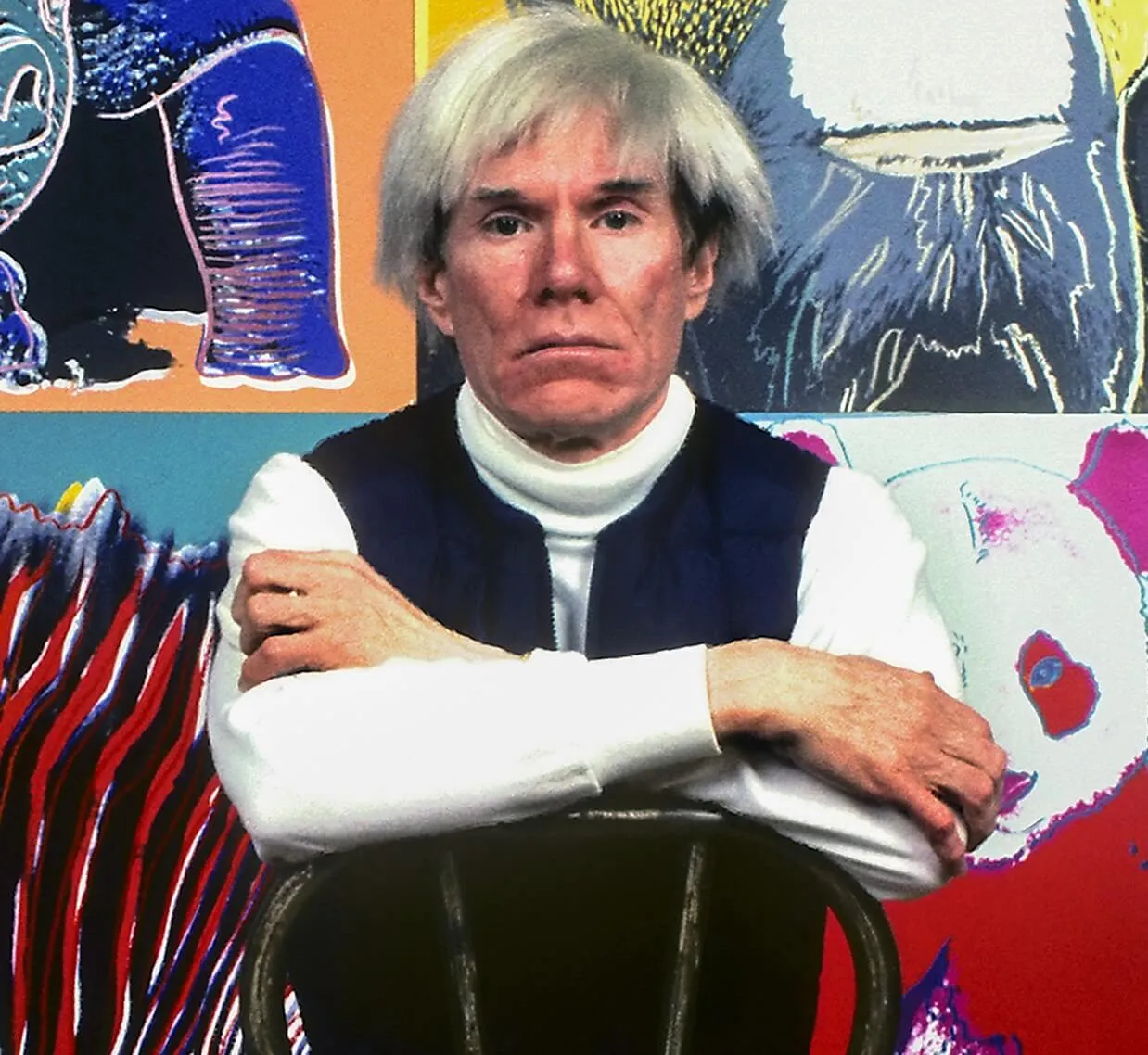 Andy Warhol with his arms folded