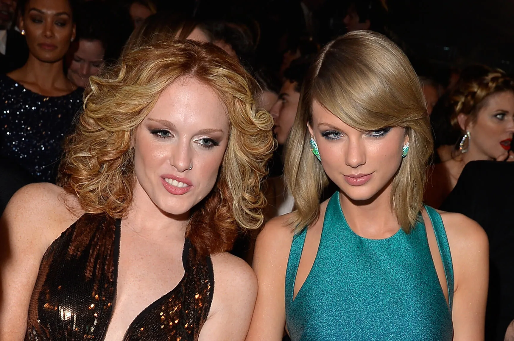 Abigail Anderson and Taylor Swift next to each other at the 57th Grammy Awards 