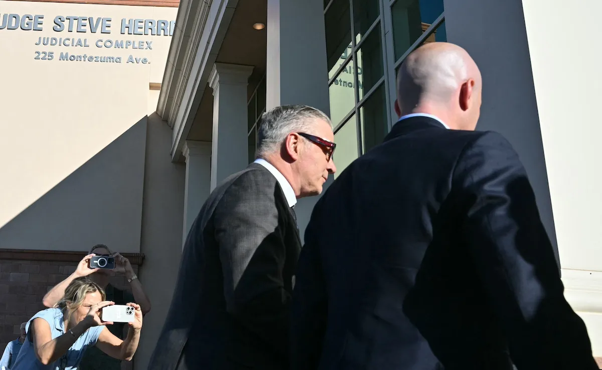 Alec Baldwin and his lawyer walking into court as onlookers take photos