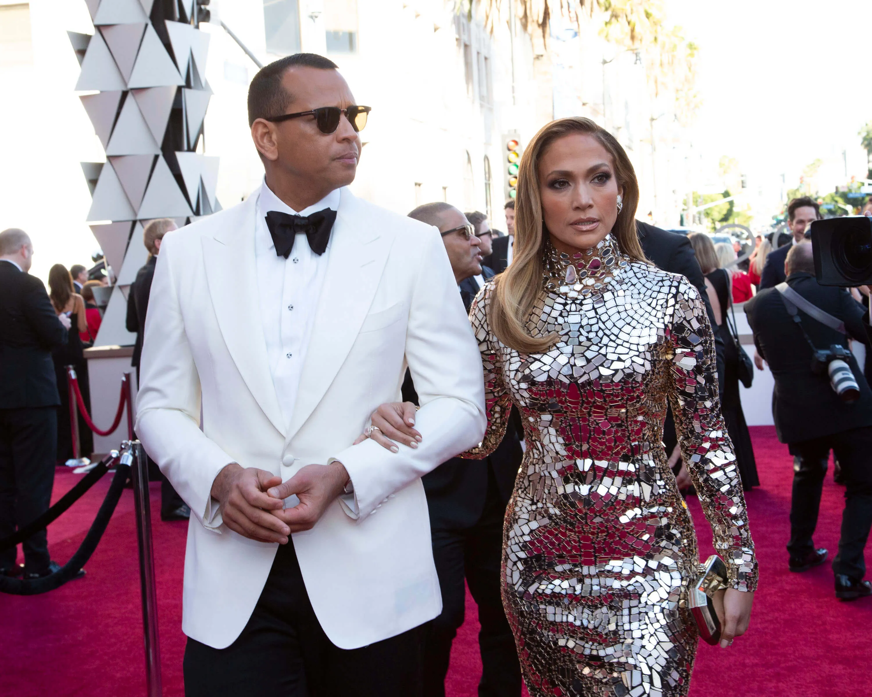 Alex Rodriguez and Jennifer Lopez walking together on the red carpet for the Academy Awards in 2019