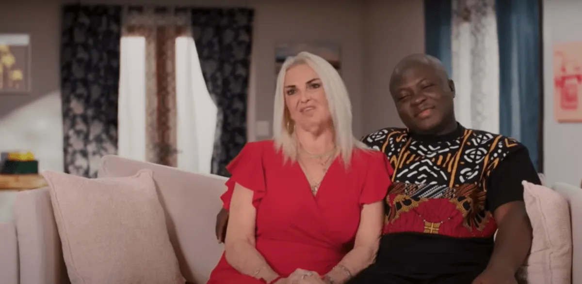 Angela and Michael sitting on a couch in '90 Day Fiance: Happily Ever After?' Season 8