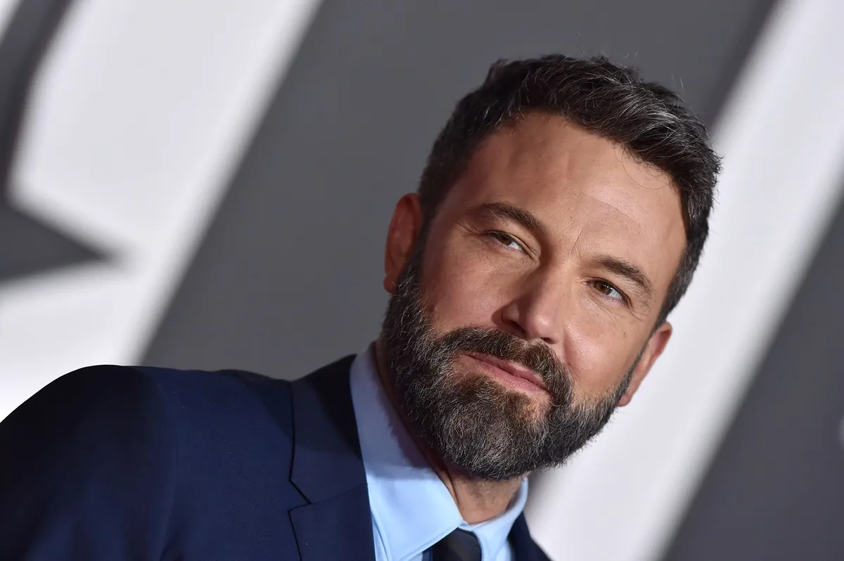 Ben Affleck posing at the premiere of 'Justice League' in a blue suit.