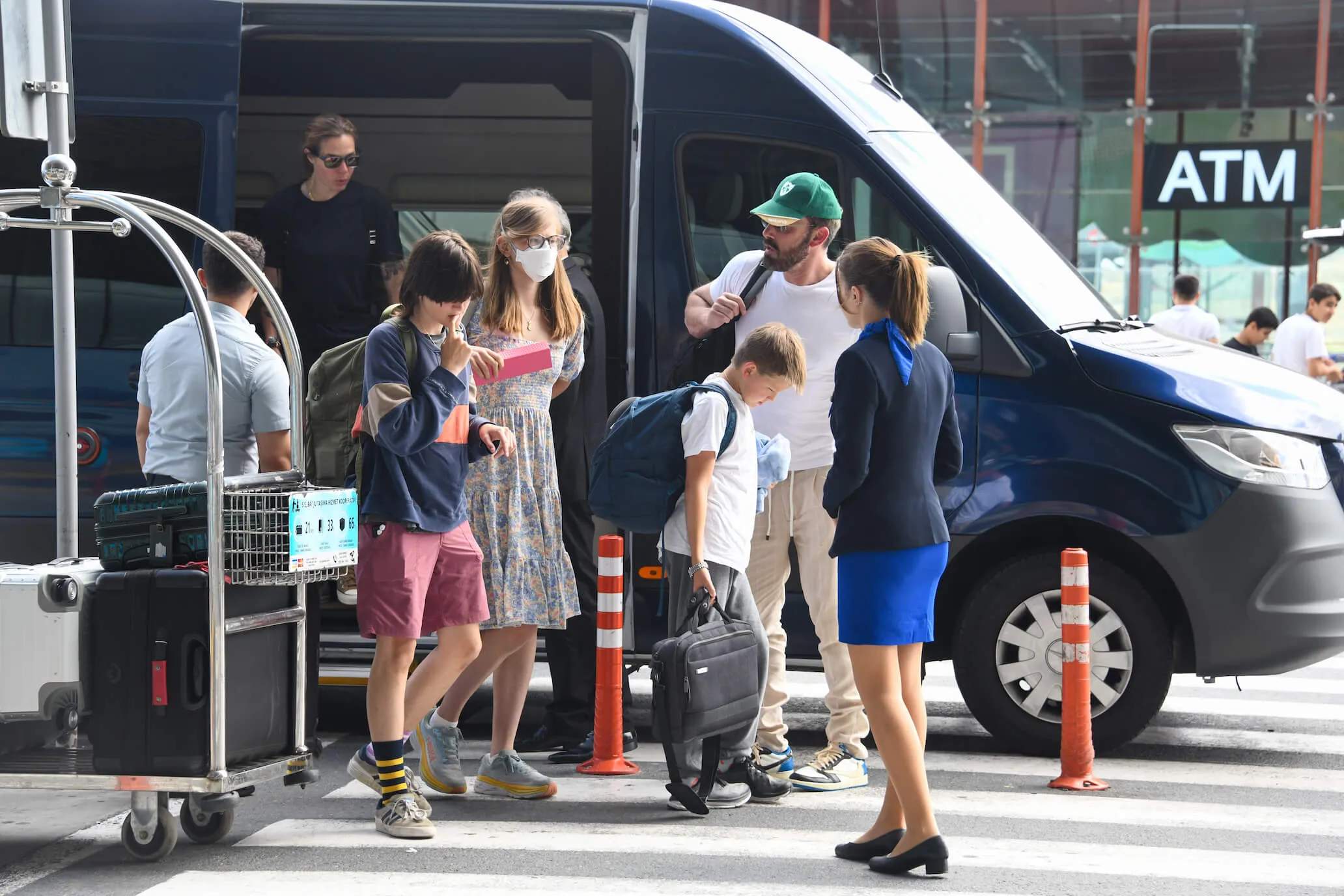 Ben Affleck with his 3 kids getting out of a van after a vacation in 2023