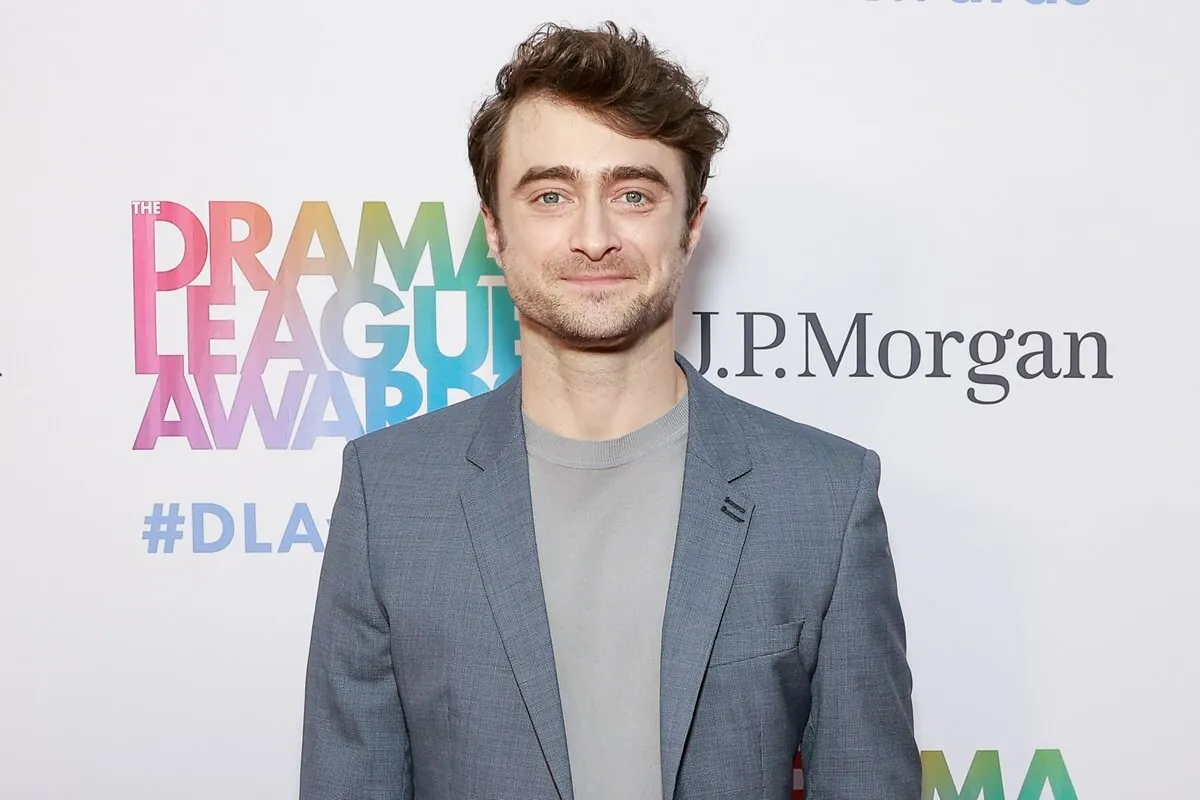 Daniel Radcliffe posing in a grey suit at the 90th annual Drama League Awards.