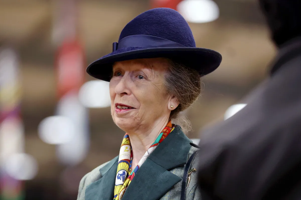 Princess Anne, who was once told she didn't 'look like a princess,' looks on wearing a blue hat