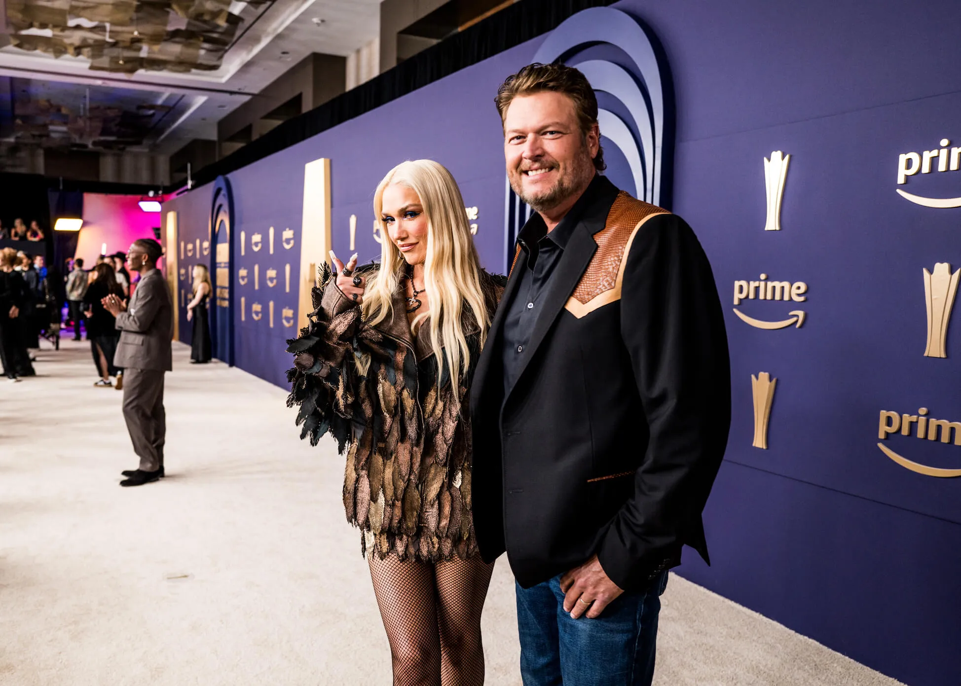 Gwen Stefani and Blake Shelton standing and posing together at the 59th Academy of Country Music Awards