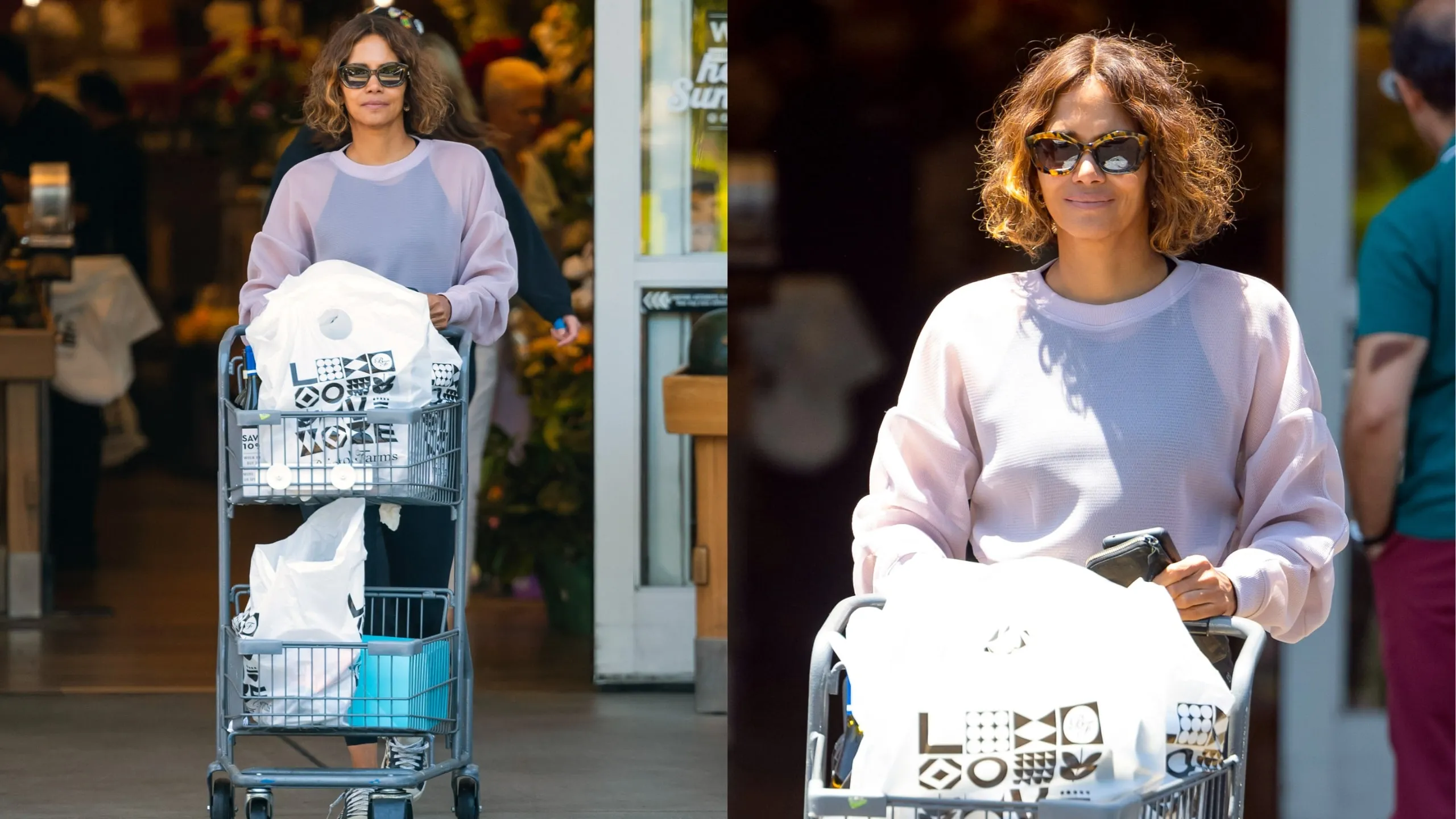 Wearing a pink sweatshirt and leggings, Hally Berry leaves a grocery store with a cart full of goods