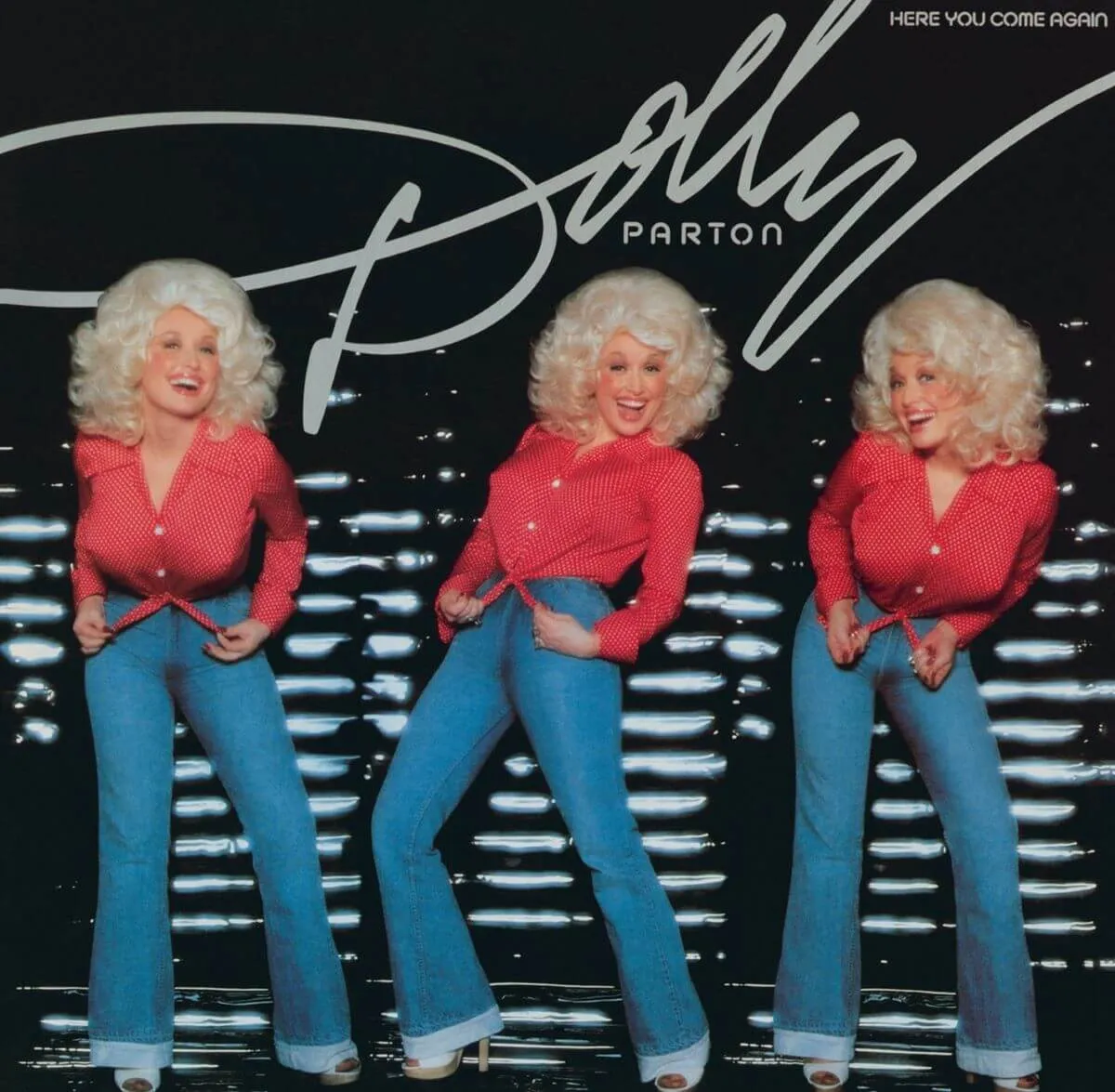 The album cover for Dolly Parton's "Here You Come Again." There are three images of Parton posing in jeans and a red shirt.