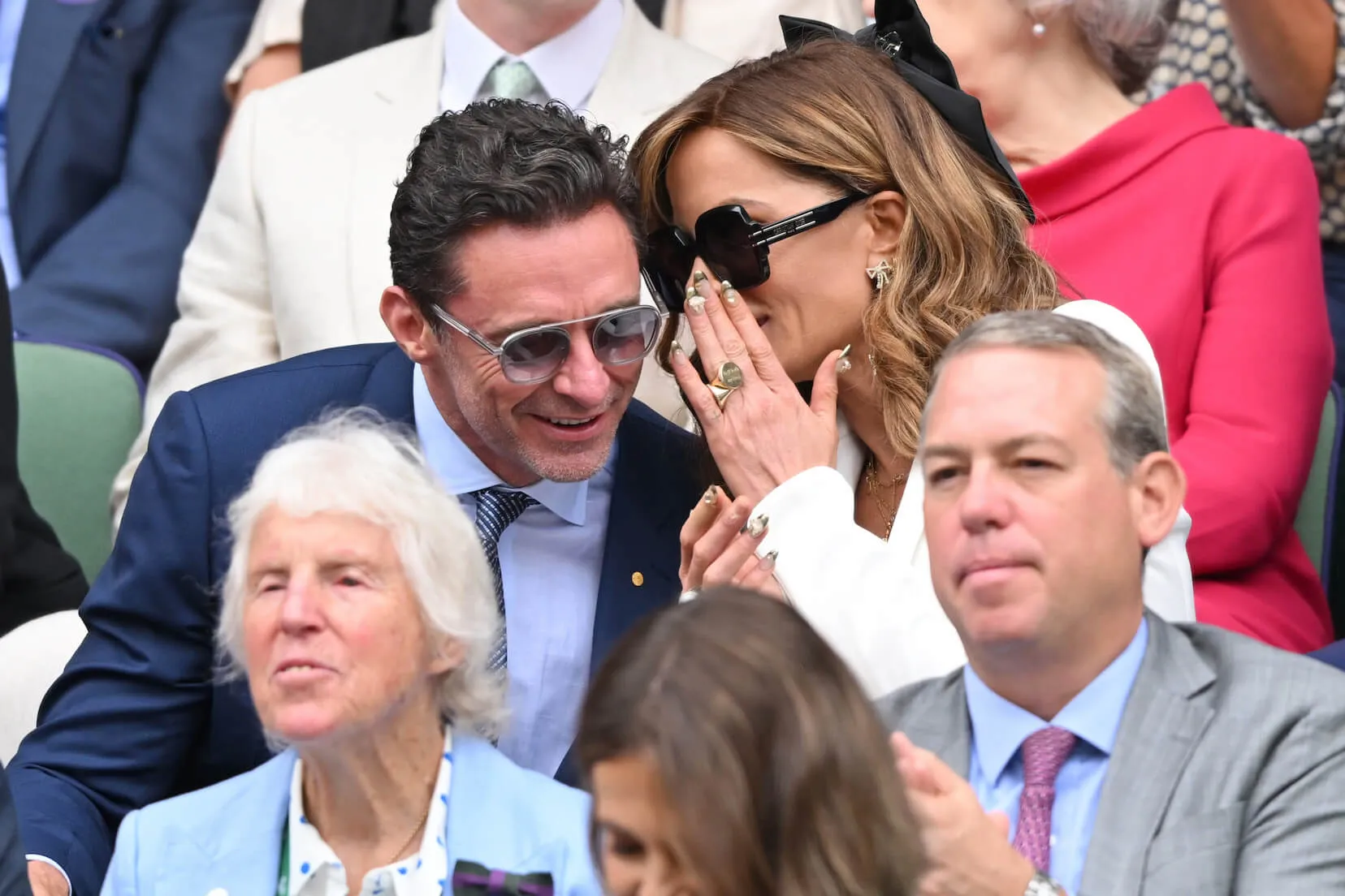 Kate Beckinsale whispering into Hugh Jackman's ear at Wimbledon in 2024