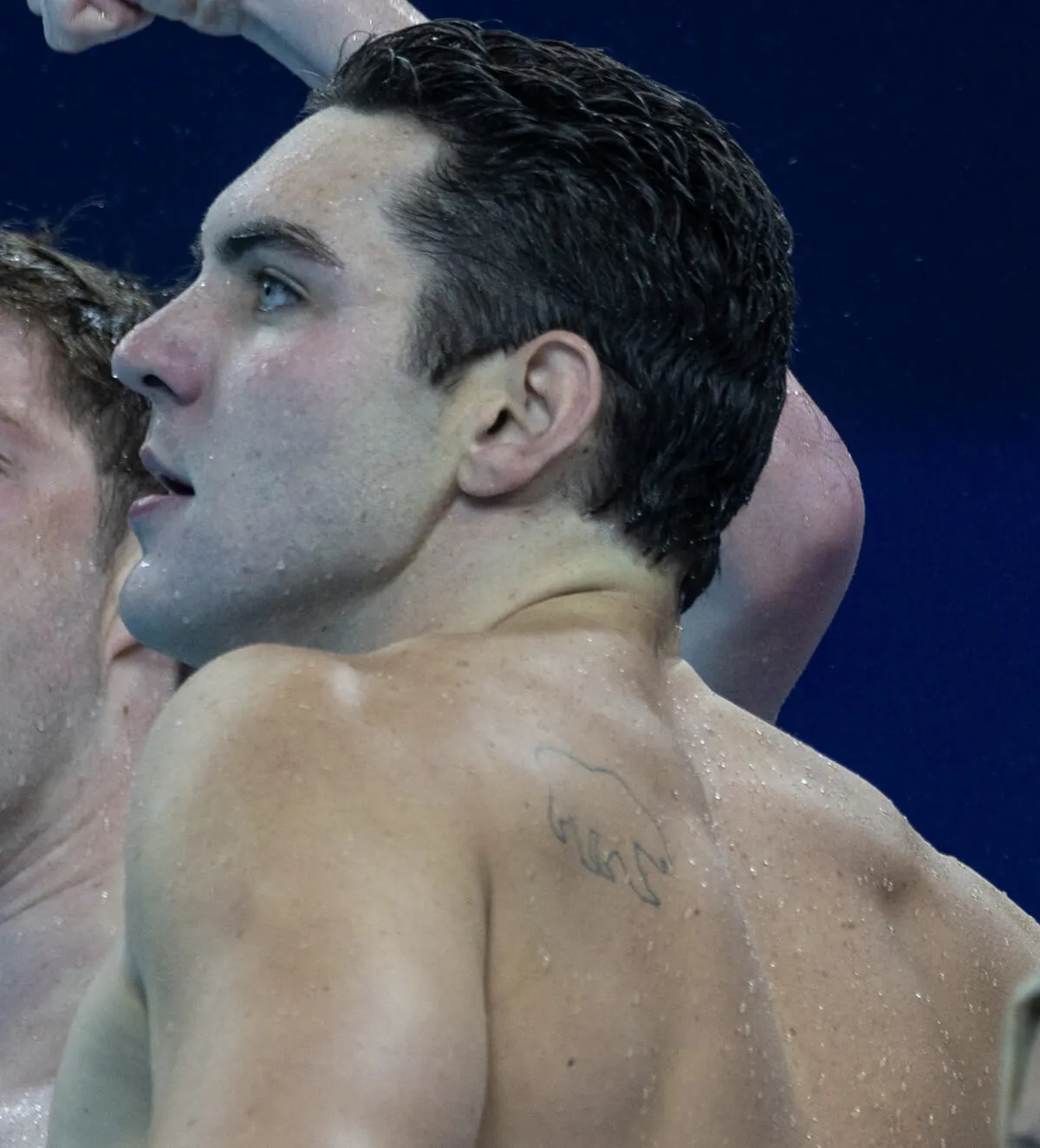 Jack Alexy's tattoo is visible as he looks on after Team USA wins the gold medal in the 4x100m Swimming Finals