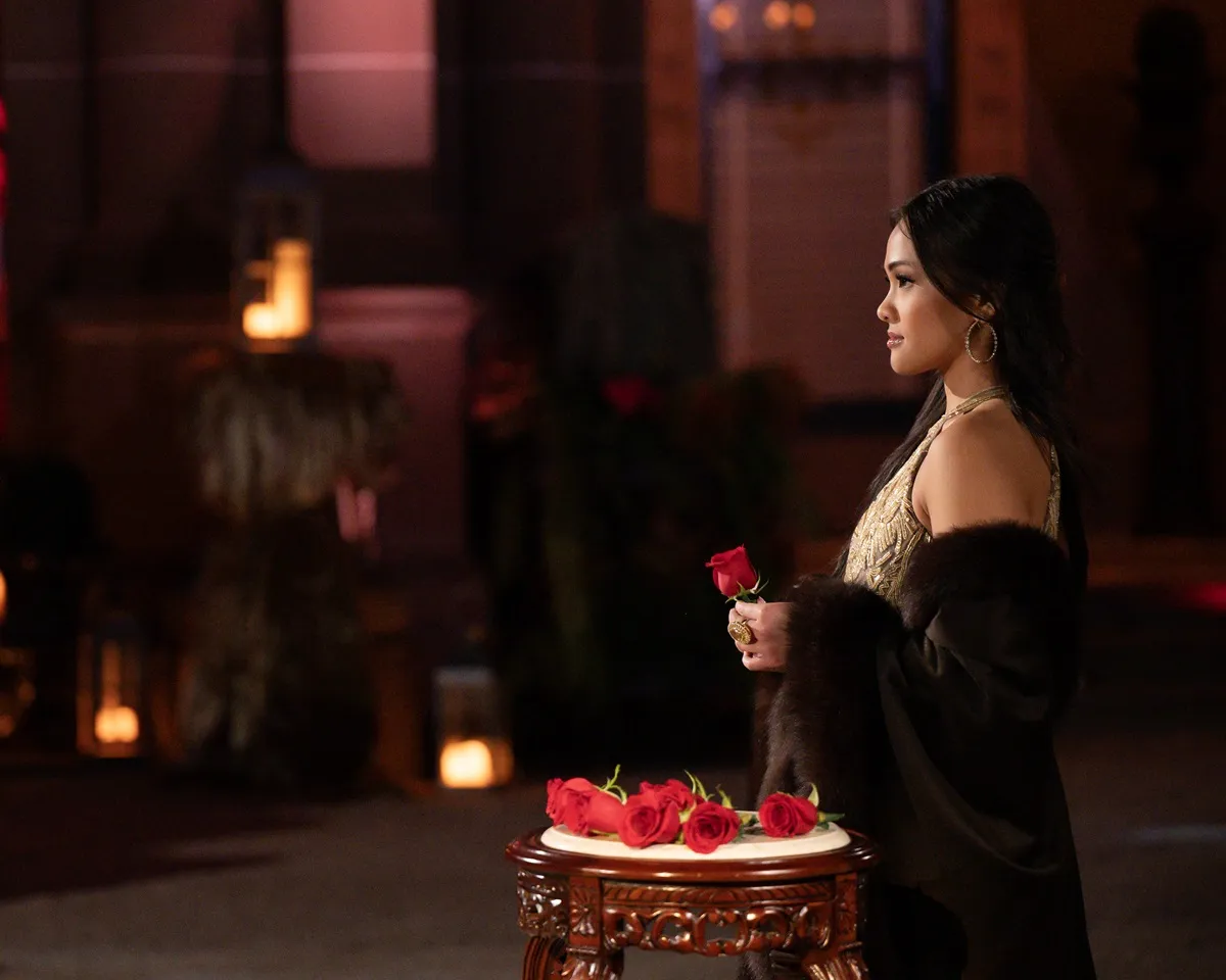 Jenn Tran is seen holding a rose at a rose ceremony in 'The Bachelorette' Season 21