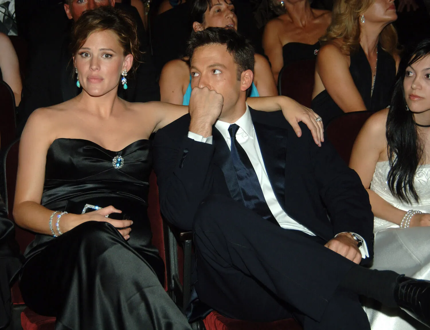 Jennifer Garner sitting in a green dress with her arm around Ben Affleck at the Emmy Awards in 2005