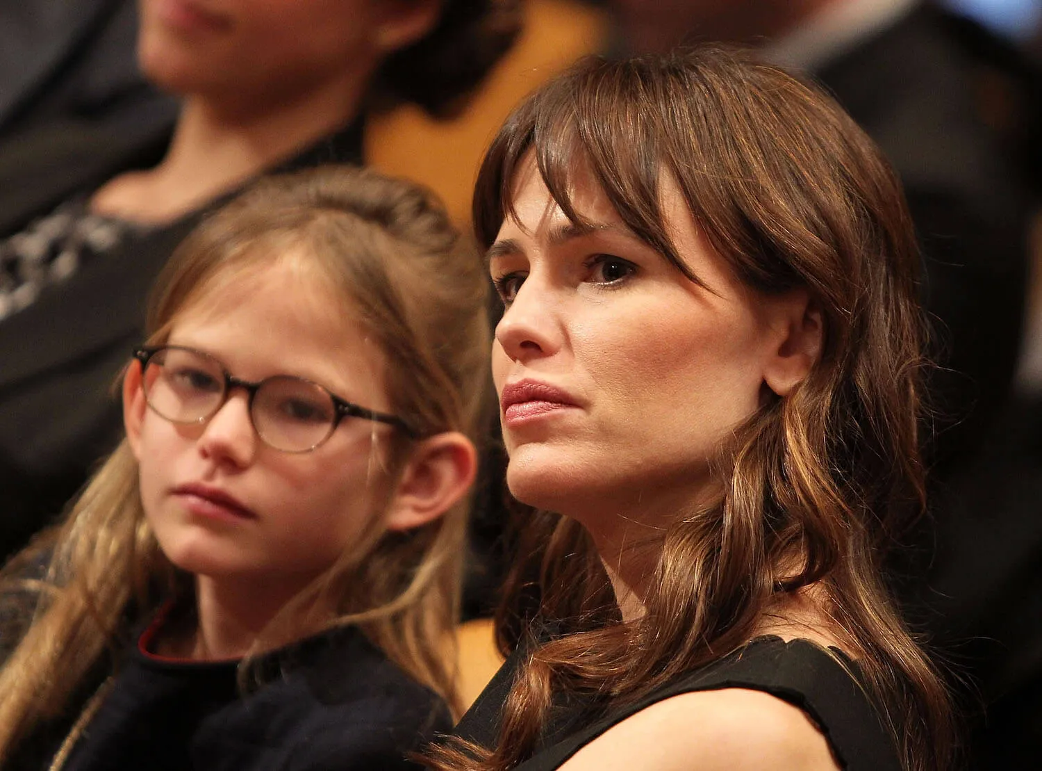 A close-up of Jennifer Garner listening closely while sitting next to her daughter, Violet, in 2015