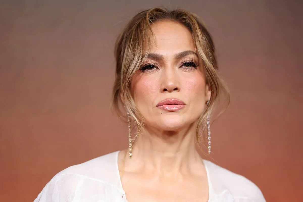 Jennifer Lopez wears a white shirt and dangly earrings.