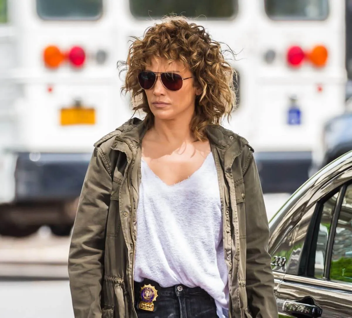 Jennifer Lopez wears a police badge, jacket, and sunglasses while filming 'Shades of Blue.'