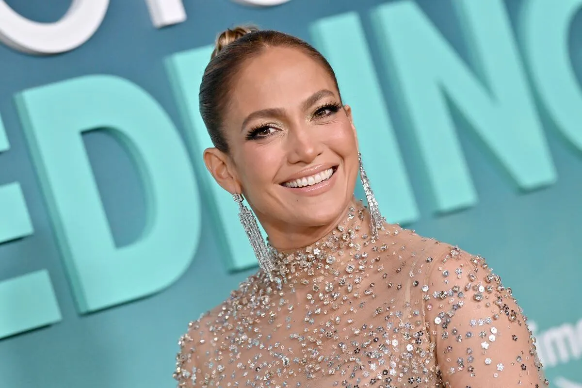 Jennifer Lopez wears a sheer sequined dress and diamond earrings.