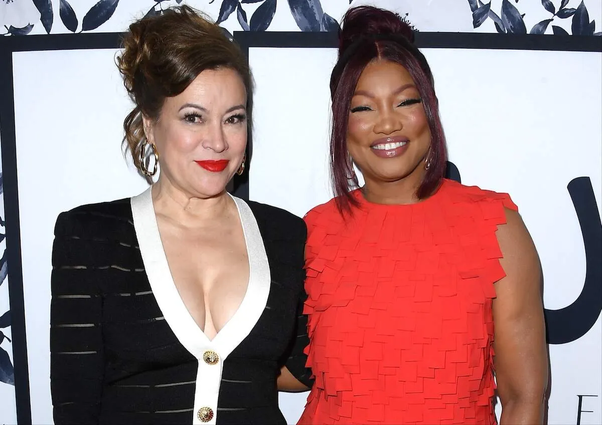 Wearing a red dress, Garcelle Beauvais arrives at Sutton Stracke's Fashion Show with Jennifer Tilly