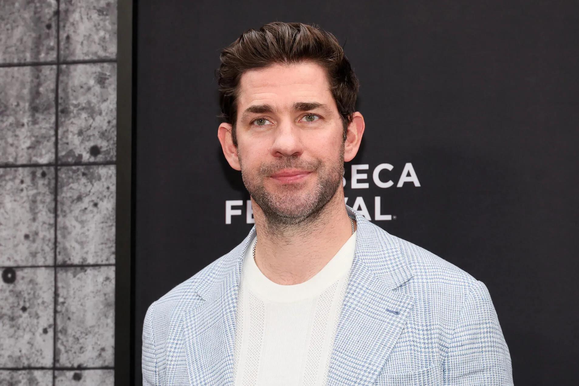 A close-up of John Krasinski wearing a blue plaid blazer and a white shirt at 'A Quiet Place: Day One' premiere