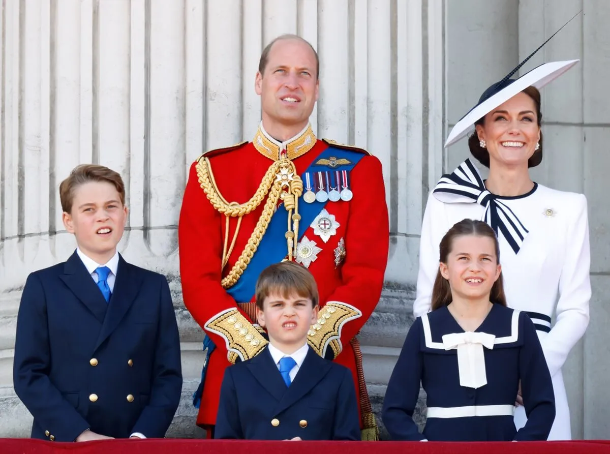 Kate Middleton, Prince William, and their children watch an RAF flypast from the balcony of Buckingham Palace after attending Trooping the Colour