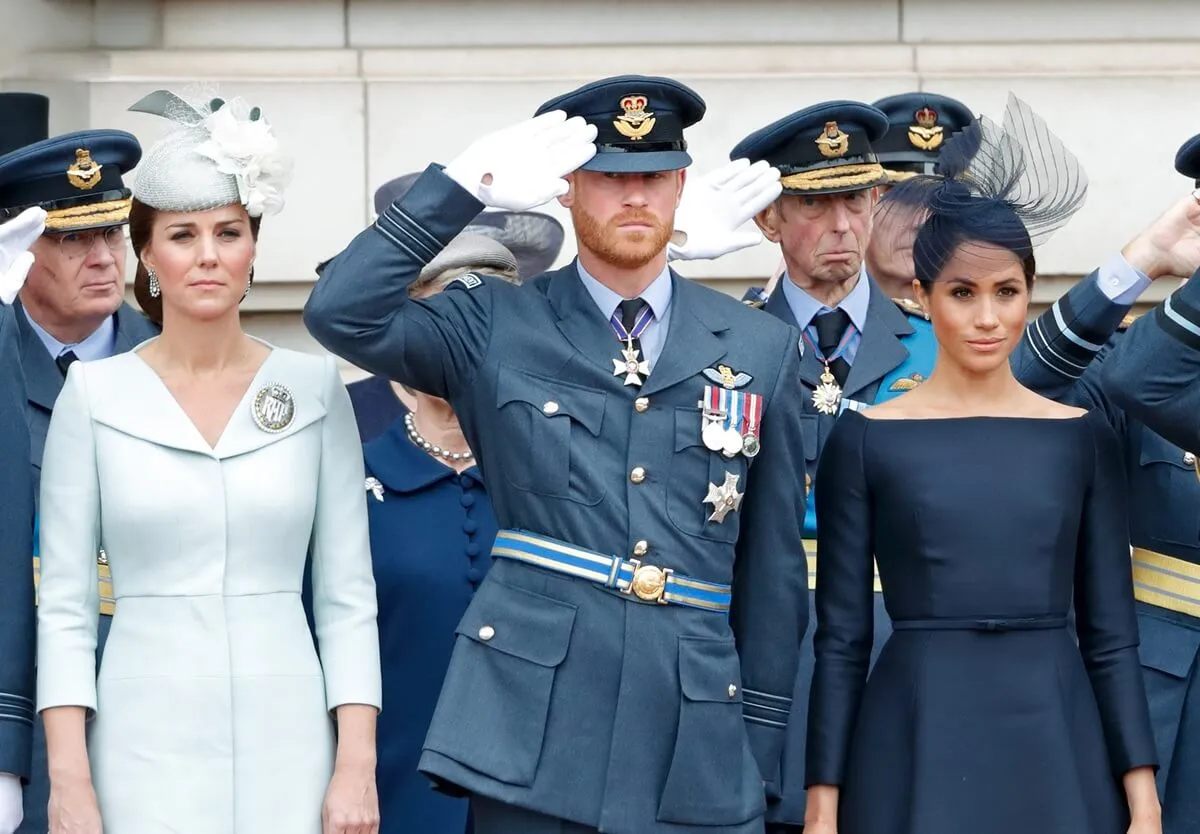 Kate Middleton and Meghan Markle along with Prince Harry attend attend a ceremony to mark the centenary of the Royal Air Force on the forecourt of Buckingham Palace