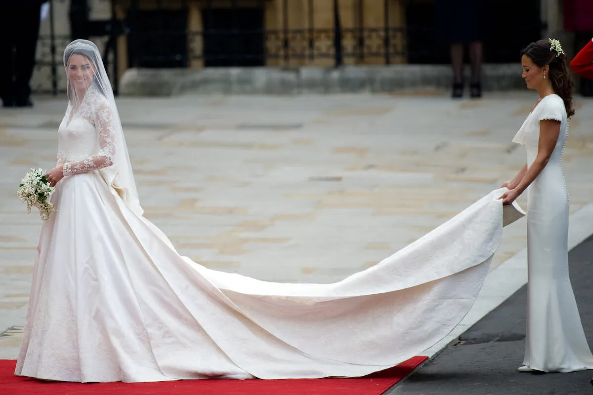 Pippa Middleton Matthews, who is closer with sister Kate Middleton as a result of her cancer diagnosis, holds Kate Middleton's wedding dress train.