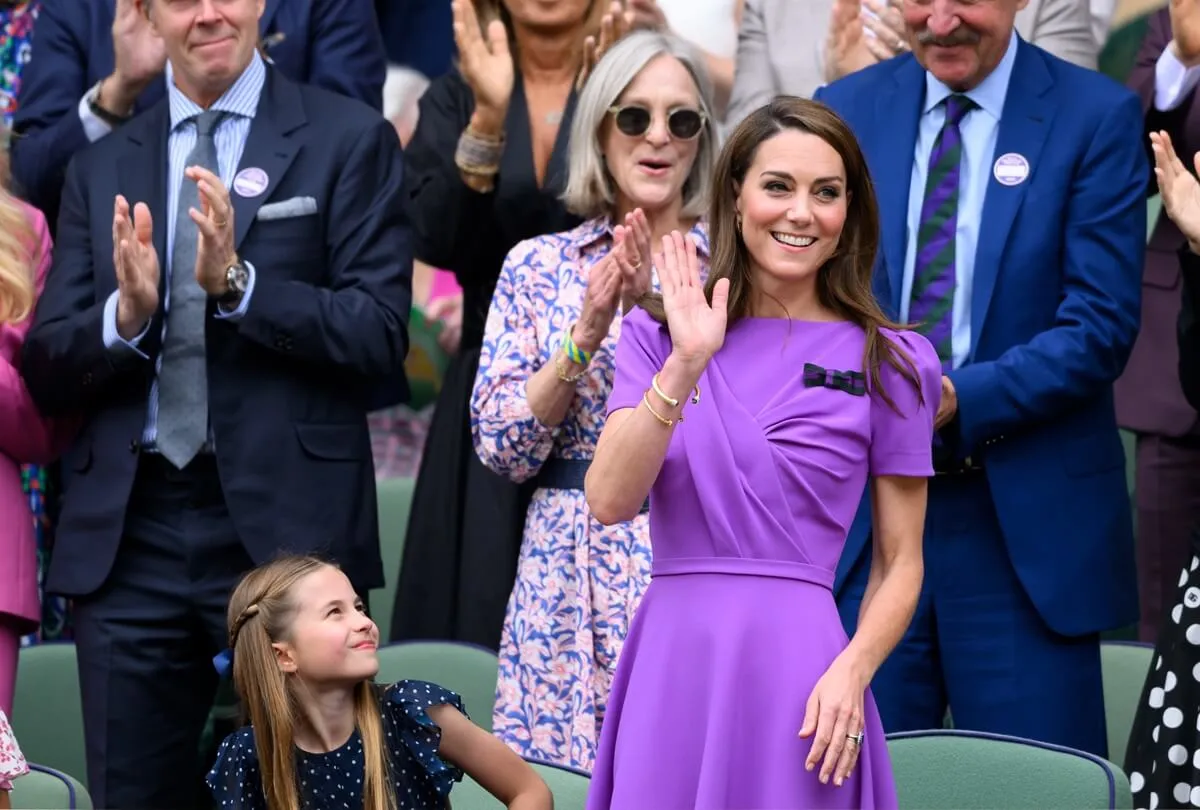 Kate Middleton receives a standing ovation during Men's Singles Wimbledon Finals as her daughter, Princess Charlotte, looks on