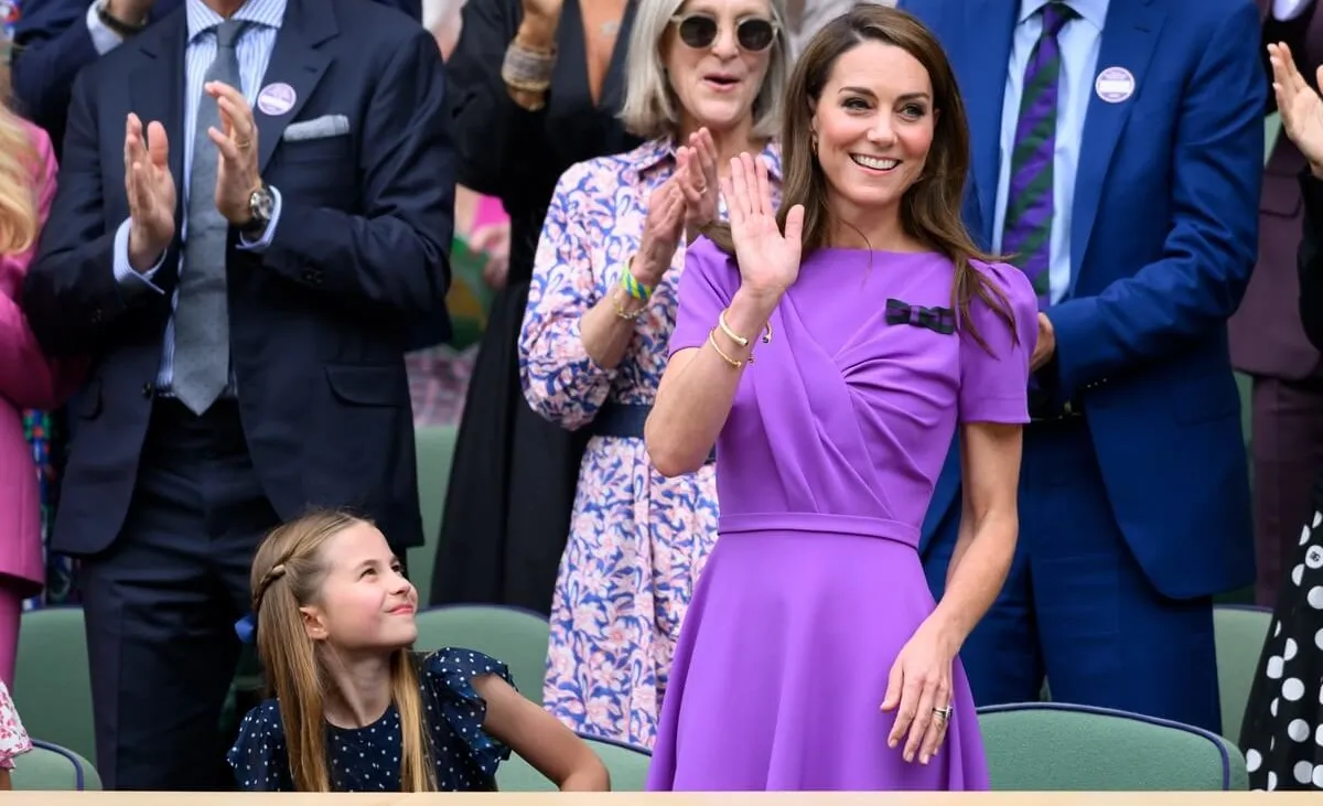 Kate Middleton waves to crowd during standing ovation as she attends Wimbledon with Princess Charlotte