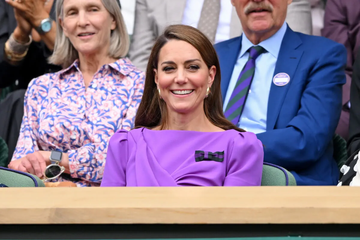 Kate Middleton, who is living life differently because of her cancer diagnosis, sits and smiles