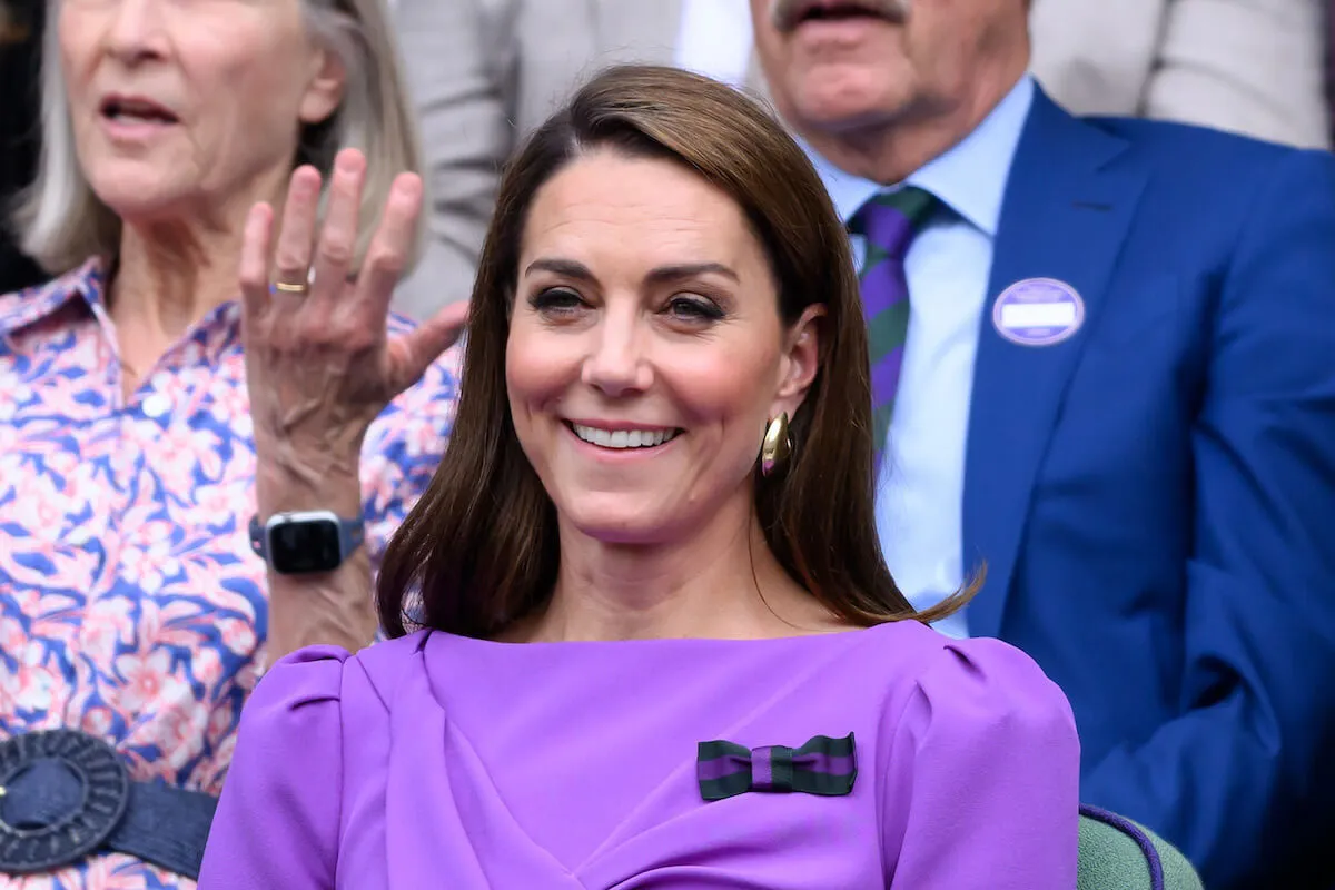 Kate Middleton, whose last public appearance for 'some time' may have been Wimbledon, at the tennis tournament wearing a purple dress