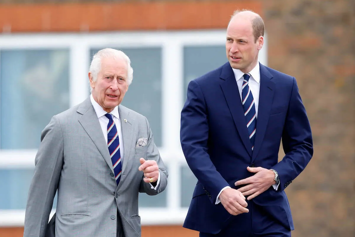 King Charles III and Prince William, whose slimmed-down monarchy is backed by a royal expert, walk.
