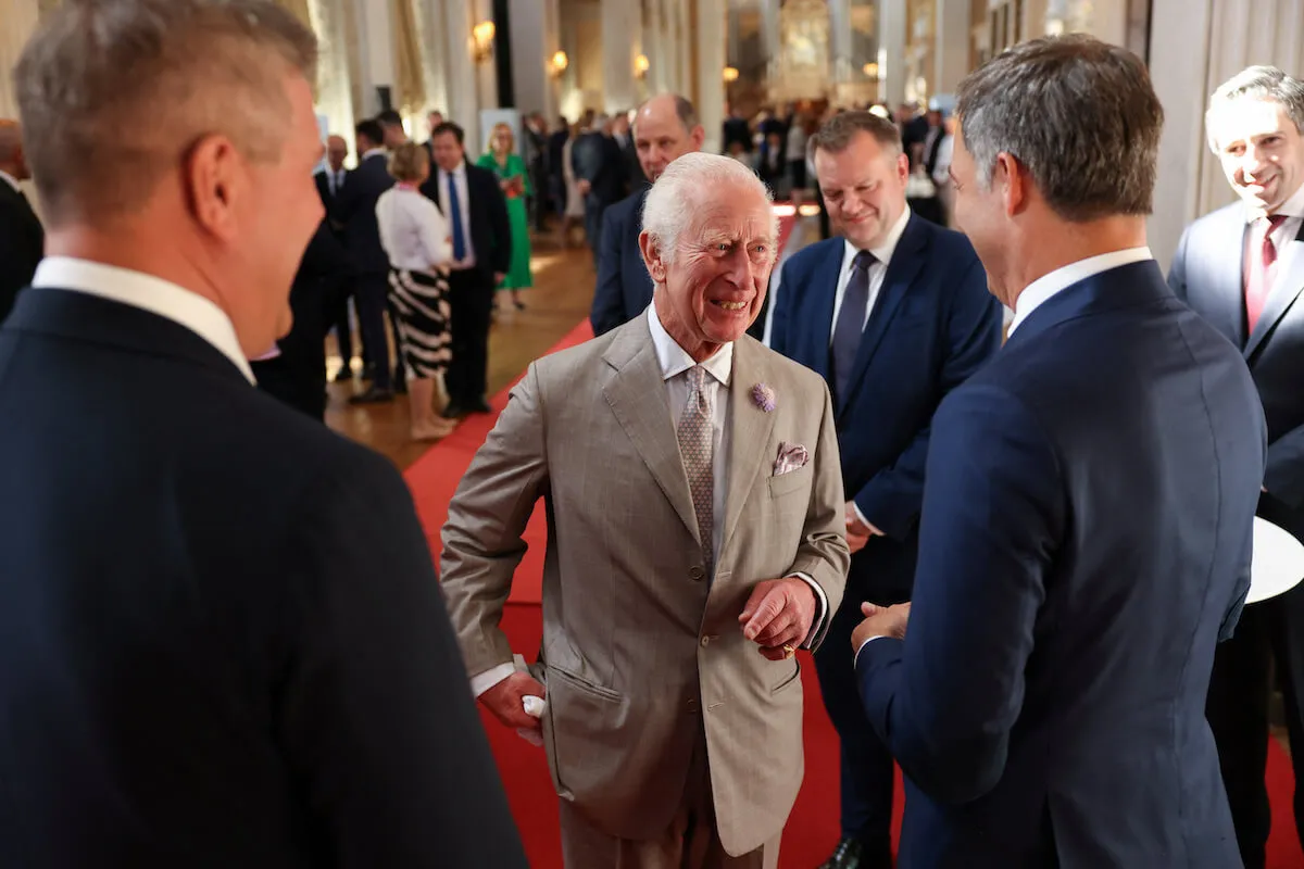 King Charles III, who stays in touch with Prince Archie and Princess Lilibet, who are Prince Harry's 'way back' to royal life, speaks with guests. 