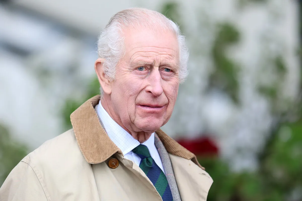 King Charles, who is reportedly considering changing the Balmoral schedule to accommodate Zara Tindall, wears a brown coat and tie.