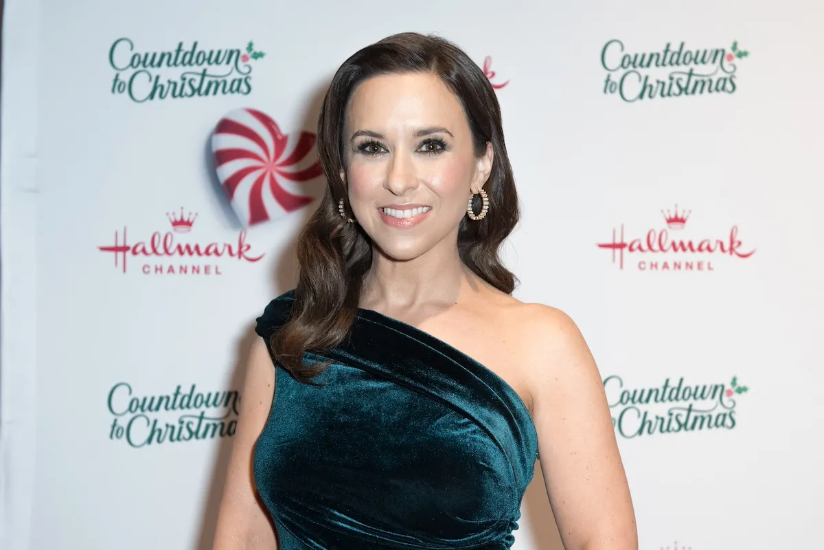 Lacey Chabert in a green velvet one-shoulder dress at a Hallmark Channel Christmas event