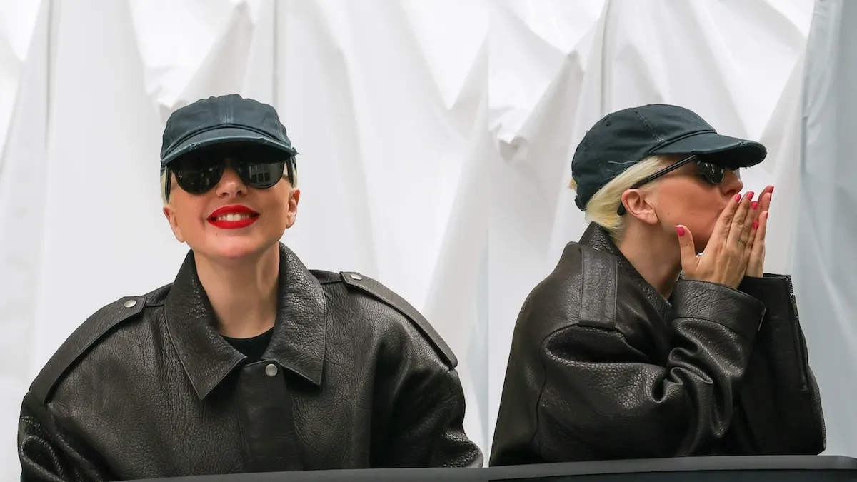 Wearing a leather jacket, Lady Gaga is seen waving to fans from her car in Paris