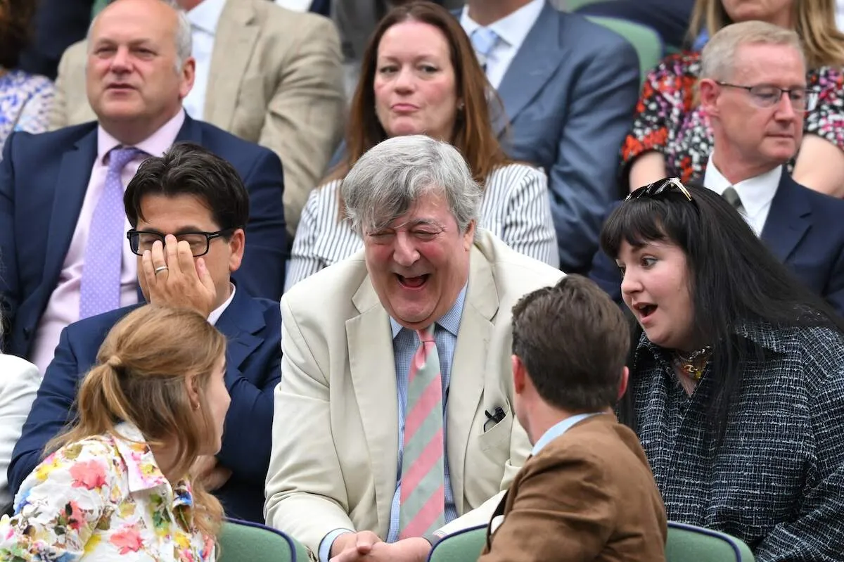 Wearing a floral dress, Princess Beatrice talks with Michael McIntyre and Lena Dunham front row at Wimbledon