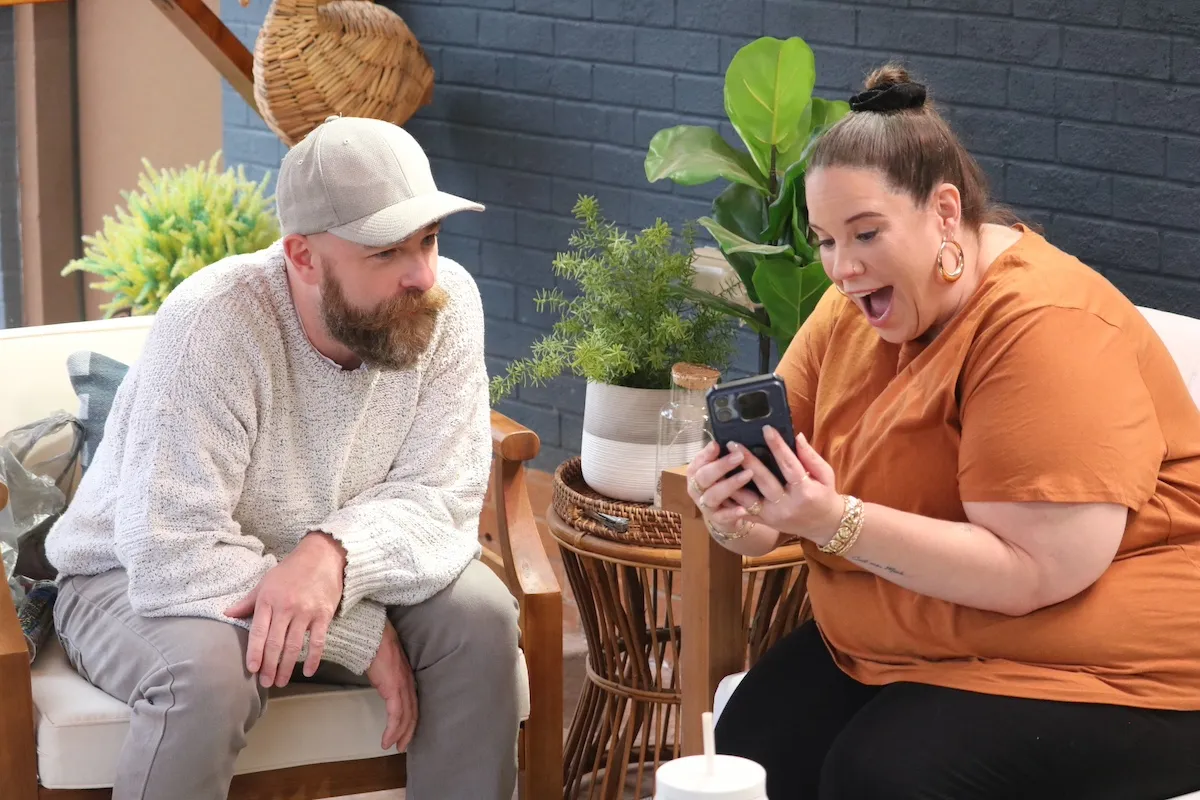 Whitney Way Thore looking at pictures on Lennie's phone in 'My Big Fat Fabulous Life' Season 12 premiere