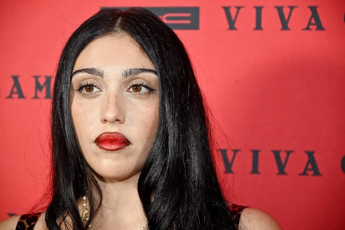 Model Lourdes Leon poses on the red carpet wearing dark red lipstick