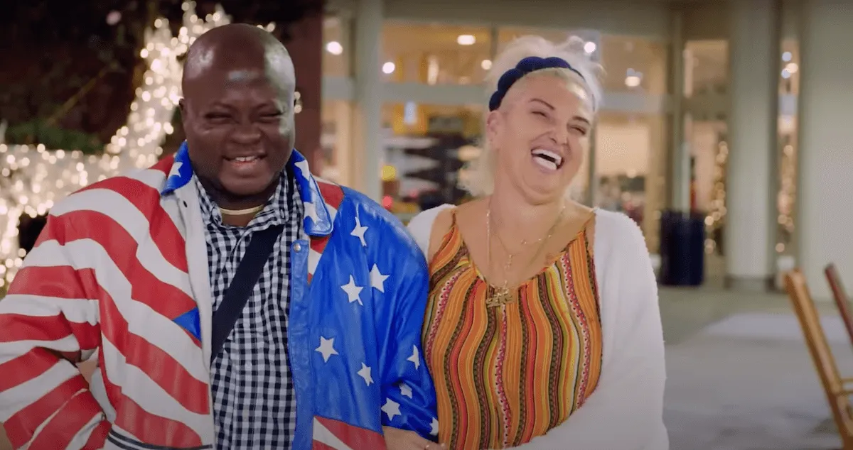 Michael Ilesanmi in an American flag jacket standing next to Angela Deem