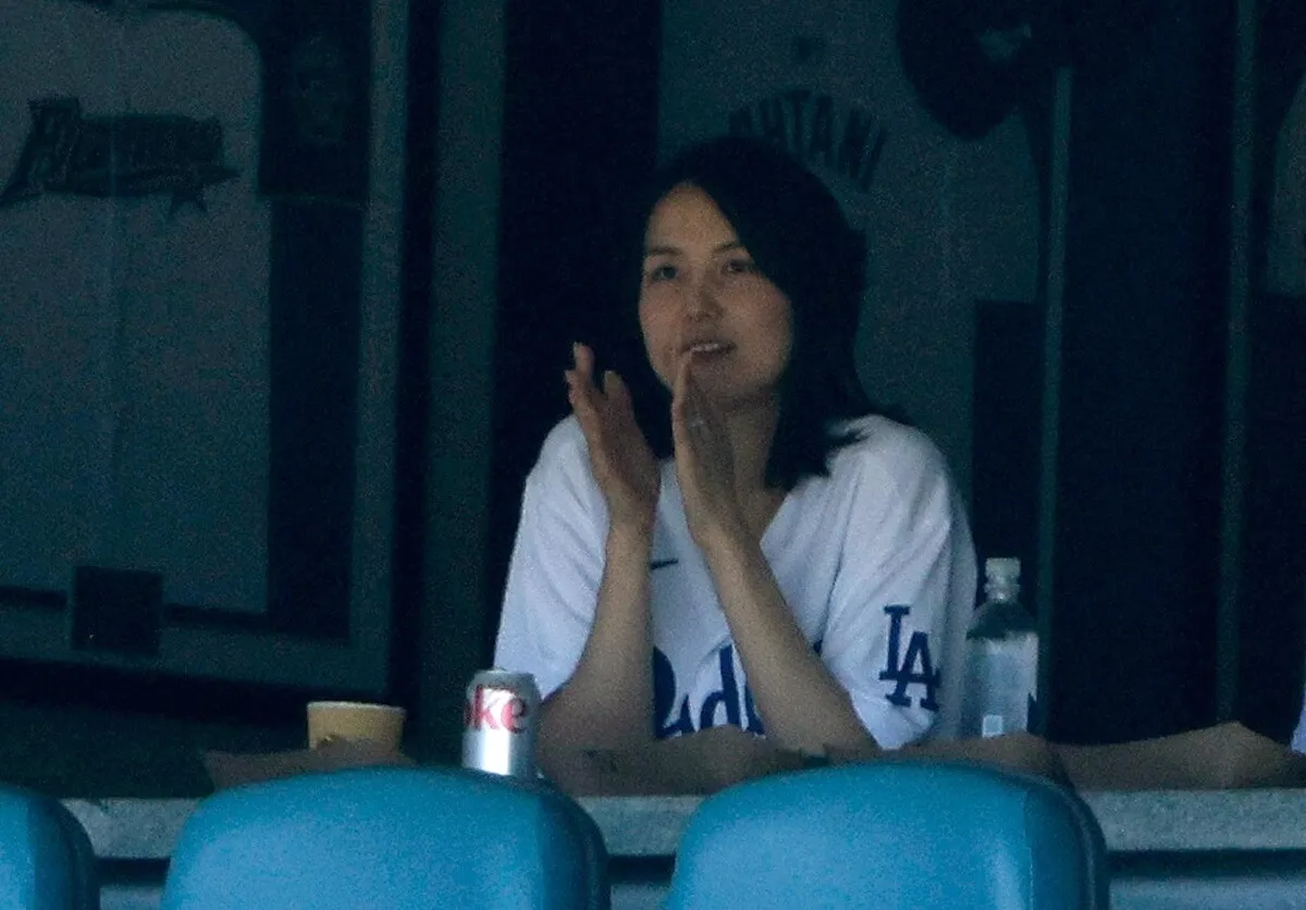 Mamiko Tanaka cheers for her husband, Shohei Ohtani, after he hits a single during a game against St. Louis Cardinals