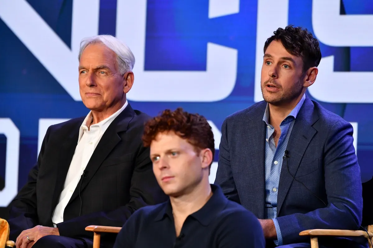 Mark Harmon and Sean Harmon sitting on stage during a TCA panel
