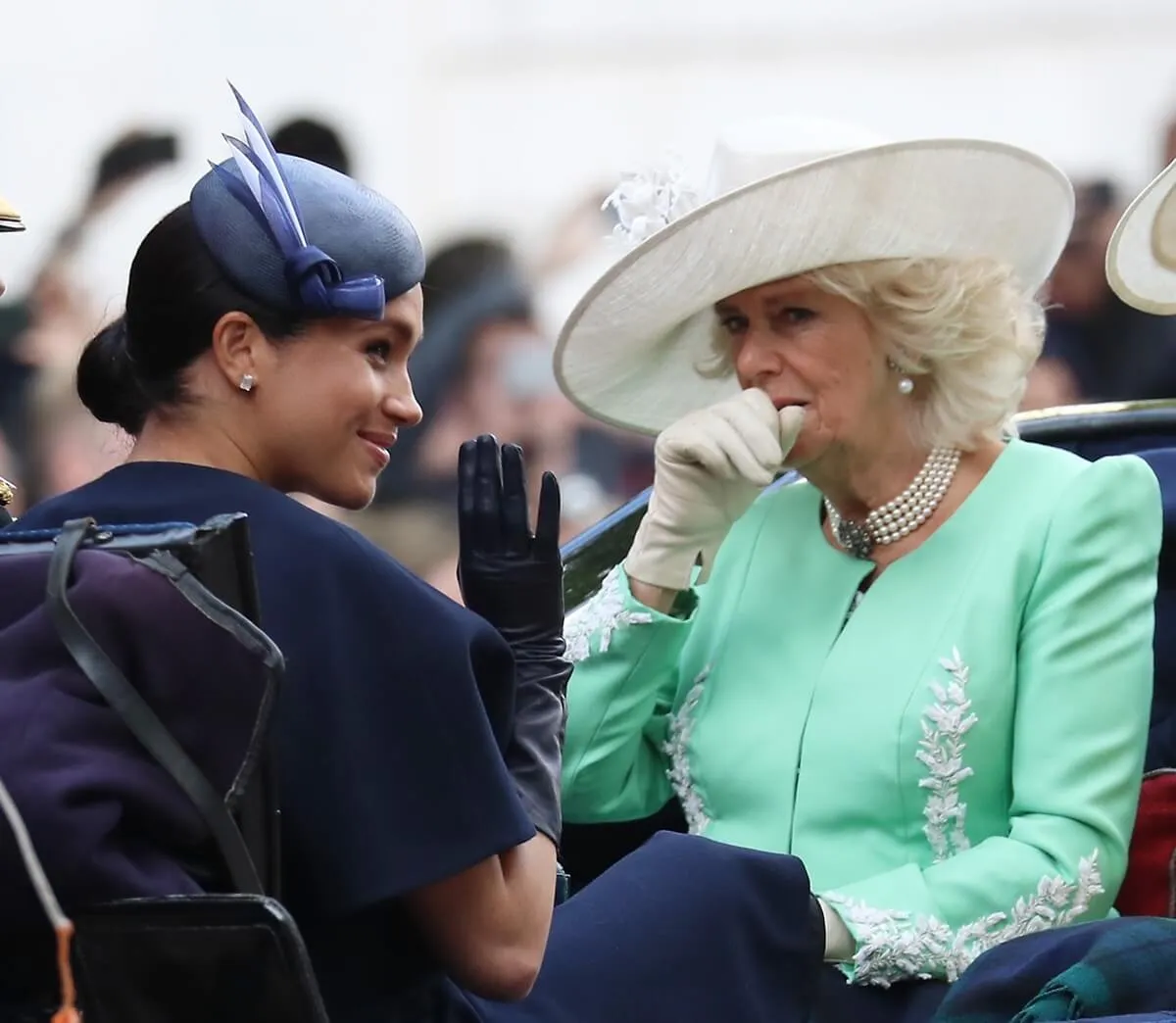 Meghan Markle and Camilla Parker Bowles (now-Queen Camilla) riding in a carriage during Trooping The Colour