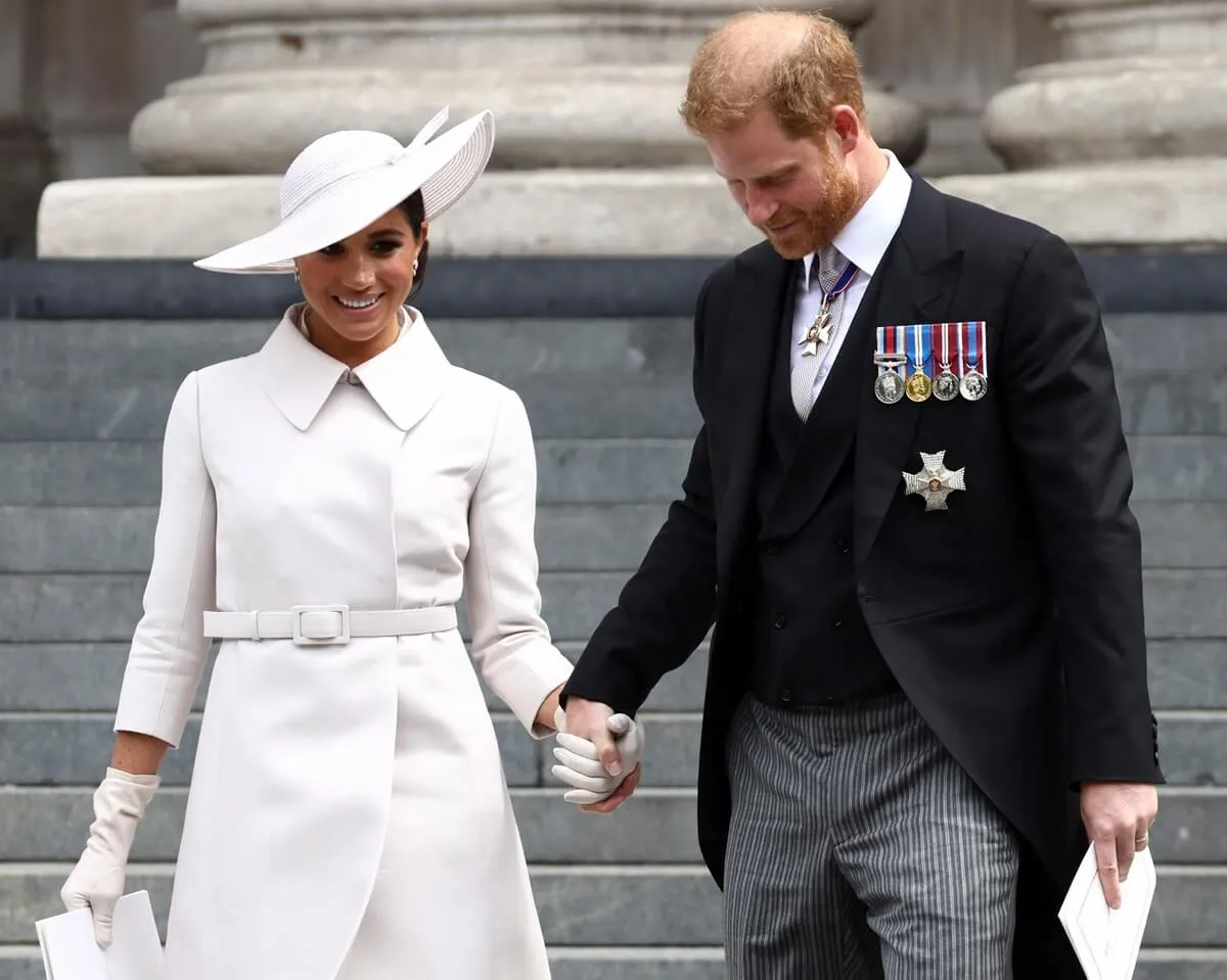 Meghan Markle and Prince Harry hold hands as they depart after the National Service of Thanksgiving to Celebrate the Platinum Jubilee of Queen Elizabeth II