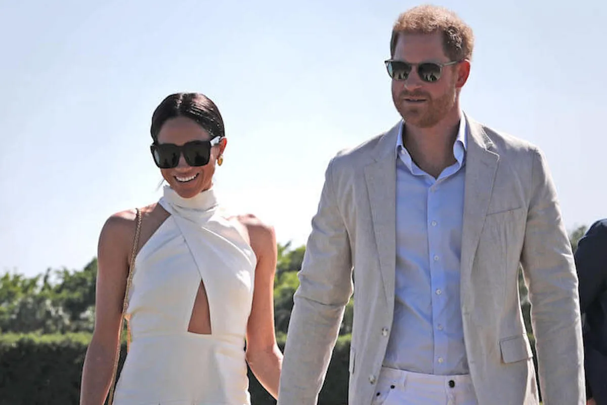 Meghan Markle and Prince Harry, who are considering bringing their children to the Invictus Games in 2025, hold hands at a polo match