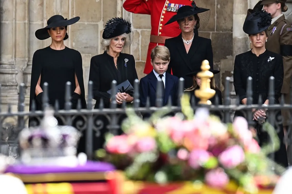 Meghan Markle, now-Queen Camilla, Prince George, Kate Middleton, and Sophie look on during Queen Elizabeth II's funeral