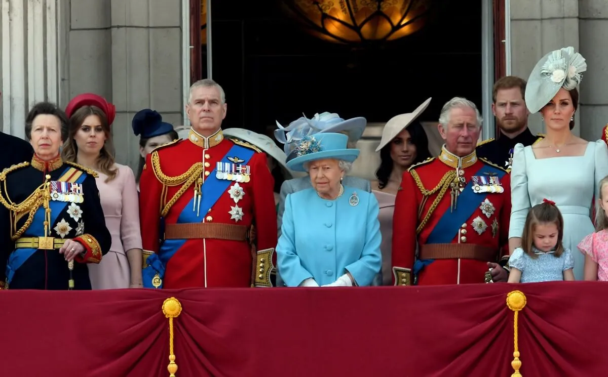 Members of the royal family including Meghan Markle, Prince Harry, and Princess Beatrice standing on the balcony of Buckingham Palace during Trooping the Colour